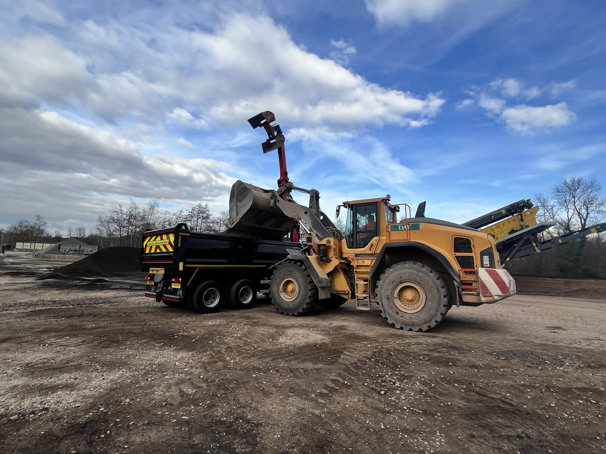 Grab lorry being loaded on a building site