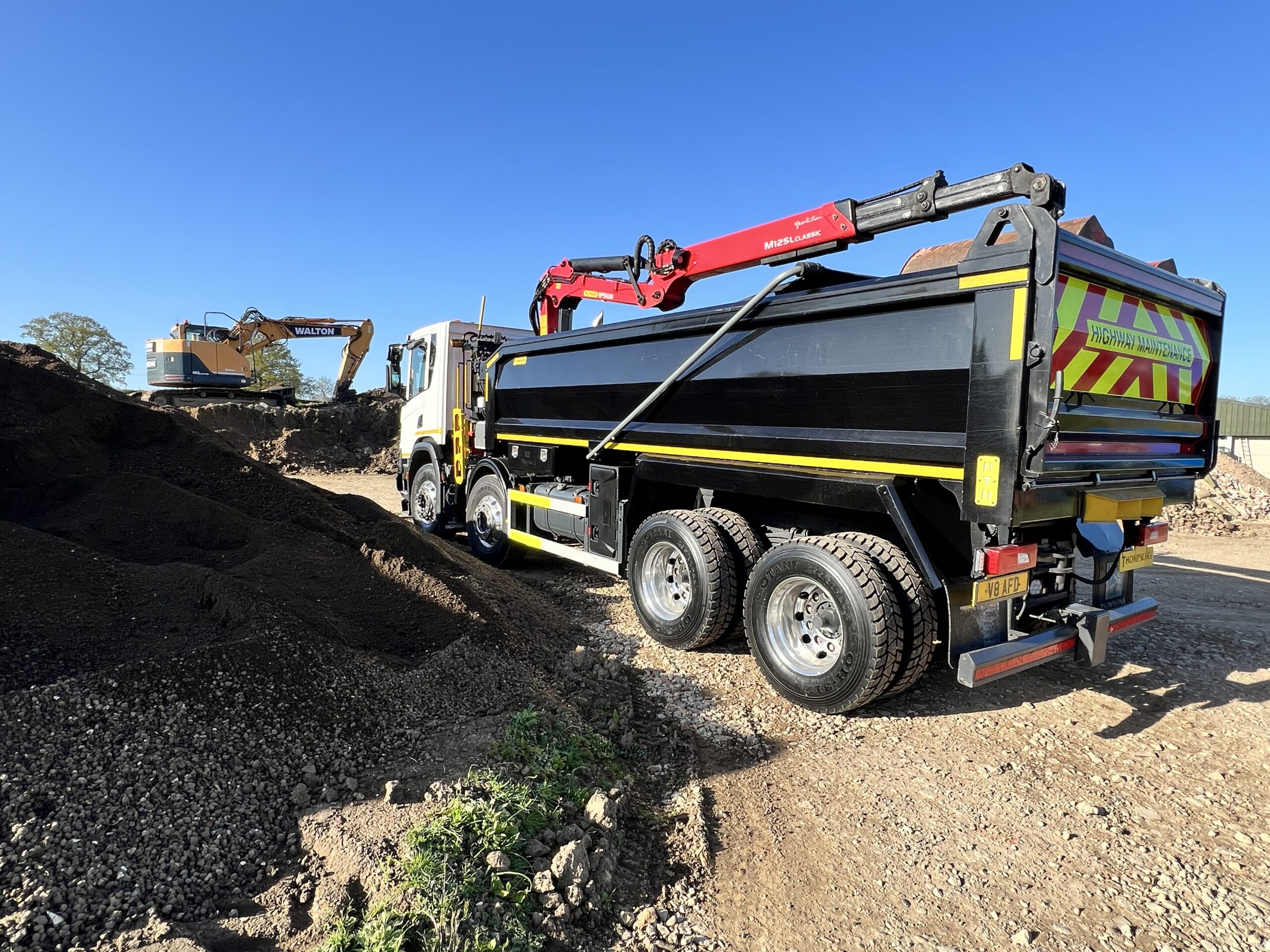 AFD Transport lorry next to aggregate stockpile